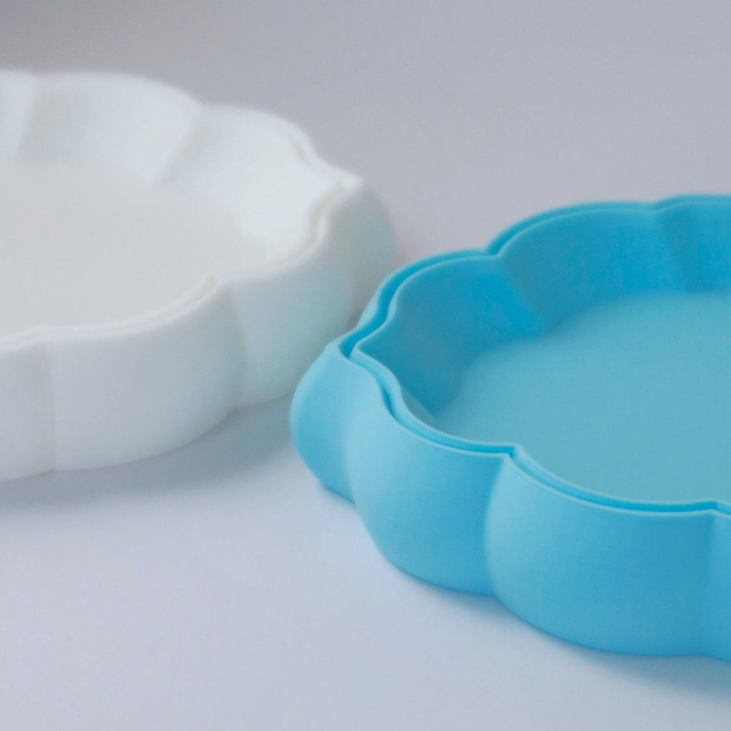 Two cloud shaped trays on a light gray background.