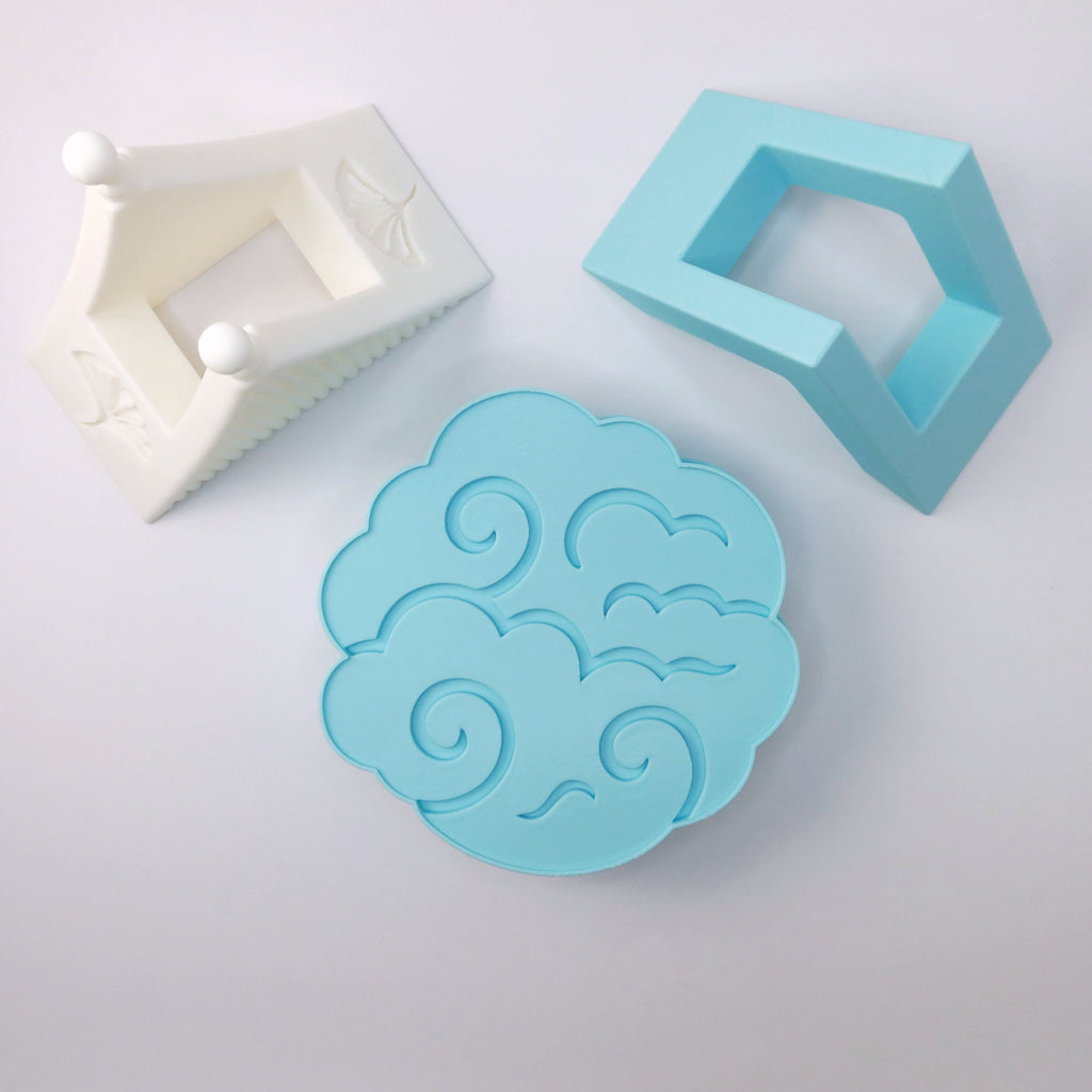 Blue cloud-shaped coasters on a white background