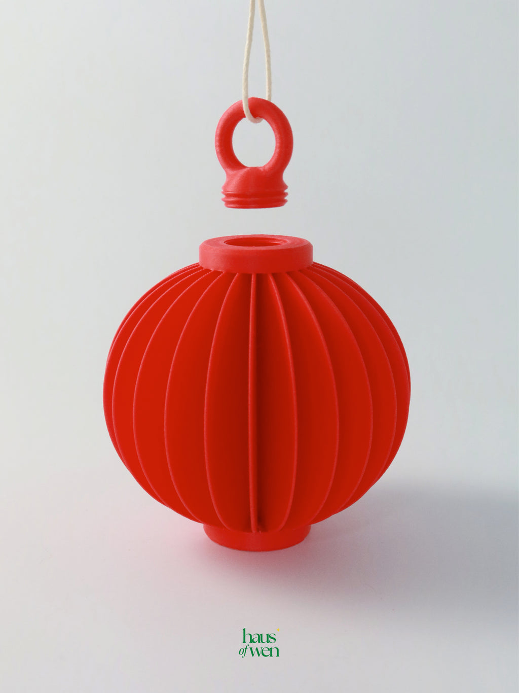 Red lantern decor with a handle on a white background in assembly view with 'haus of wen' brand visible.