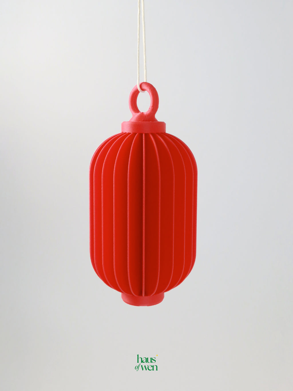 Red lantern-shaped ornament on a white background with 'haus of wen' brand visible.