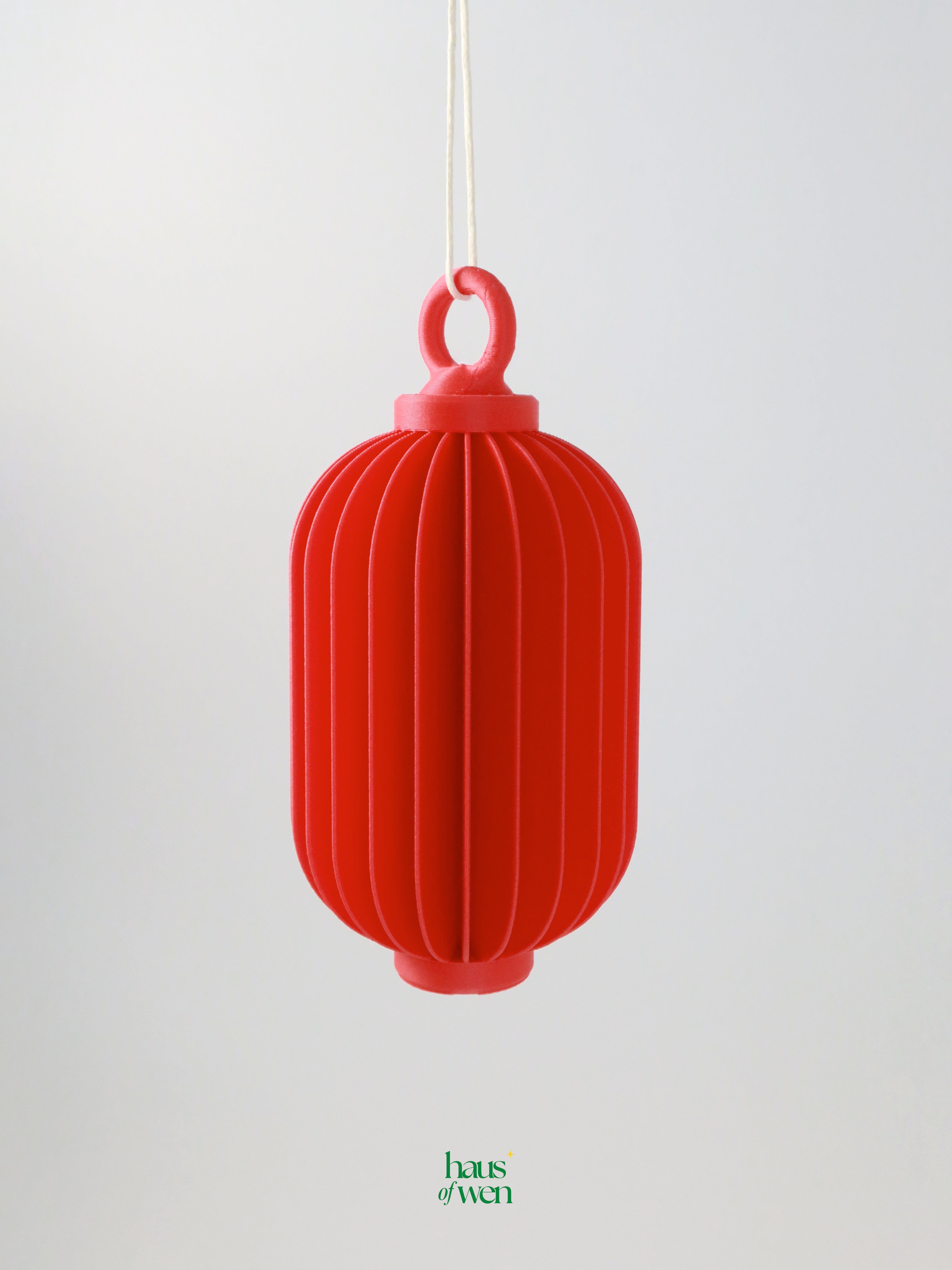 Red lantern-shaped ornament on a white background with 'haus of wen' brand visible.